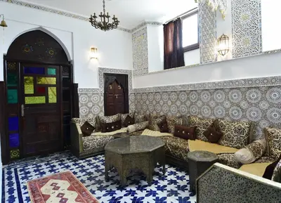 a living room with a couch and a table at Dar Aya Fes in Fès