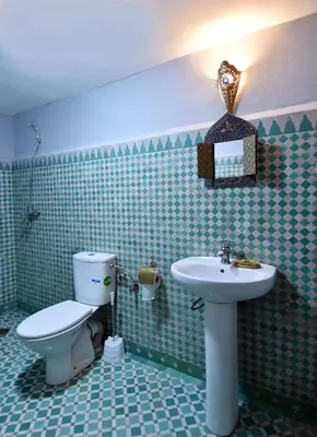 a bathroom with a toilet and a sink at Dar Aya Fes in Fès