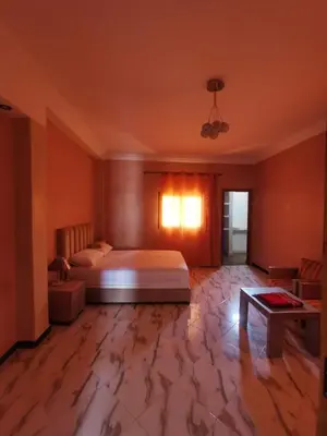 a bedroom with a bed and a table in it at Villa Baraka in Marrakech