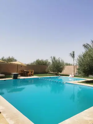 a large swimming pool with blue water at Villa Baraka in Marrakech