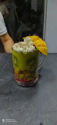 a dessert with fruit in a glass on a table at Hotel Achark in Bou Arfa