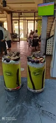 two desserts sitting on top of a table at Hotel Achark in Bou Arfa