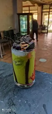 a drink sitting on top of a table at Hotel Achark in Bou Arfa
