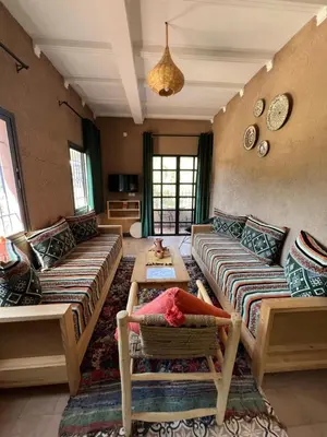 a living room with two couches and a table at Tazart Lodge in Marrakech
