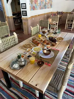 a wooden table with food on top of it at Tazart Lodge in Marrakech