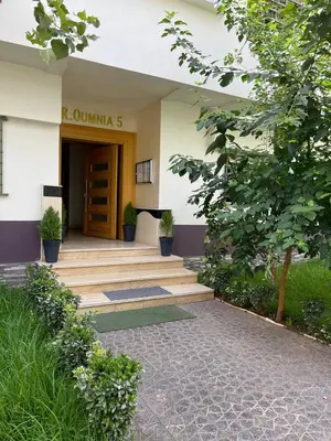 a building with a wooden door and some plants at Private, Air Conditionner and Free Parking in Fès