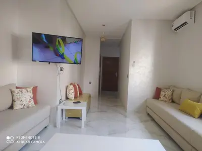 a living room with a couch and a flat screen tv at Private, Air Conditionner and Free Parking in Fès