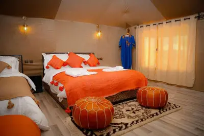 a bedroom with a bed with pumpkins on it at Desert Magic Camp in Merzouga