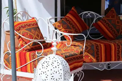 a couple of beds with pillows on them at Desert Magic Camp in Merzouga