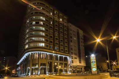 a large building at night with street lights at Hotel Tafilalet in Meknès
