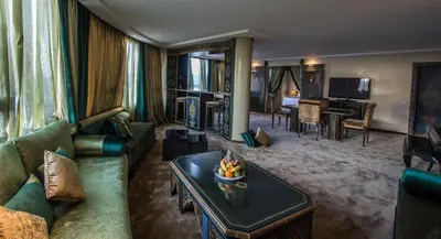 a living room with a couch and a table at Hotel Tafilalet in Meknès