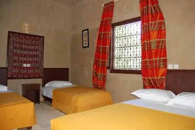 a room with two beds and a window at Auberge Amellagou in Amellagou