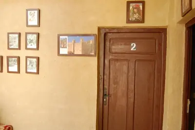 a door in a room with pictures on the wall at Auberge Amellagou in Amellagou