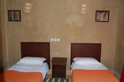 two beds sitting next to each other in a room at Auberge Amellagou in Amellagou