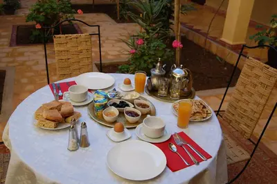 a table with plates of breakfast food on it at Auberge Amellagou in Amellagou