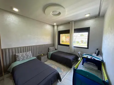 a small bedroom with two beds and a window at Chalet villa QUE POUR LES FAMILLES in Imouzzer Kandar