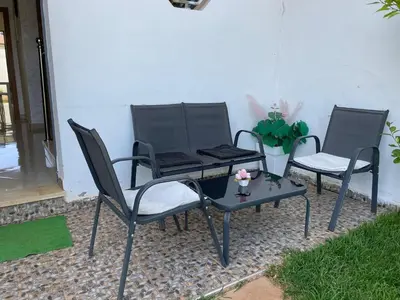 two chairs and a table on a patio at Chalet villa QUE POUR LES FAMILLES in Imouzzer Kandar