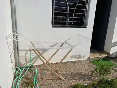 a white chair sitting in front of a building at Chalet villa QUE POUR LES FAMILLES in Imouzzer Kandar