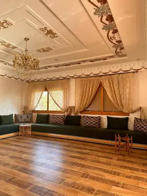 a living room with a couch and a chandelier at AYOR FES in El Oulaij