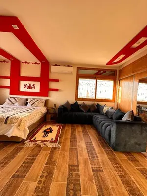 a living room with a couch and a bed at AYOR FES in El Oulaij