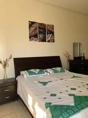 a bedroom with a large bed with two pillows at Appartement meublé à louer in Meknès
