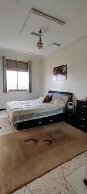 a bedroom with a large bed in a room at Appartement meublé à louer in Meknès