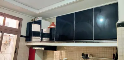 a kitchen with large glass cabinets on the counter at Appartement meublé à louer in Meknès