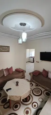 a living room with a couch and a table at Appartement meublé à louer in Meknès