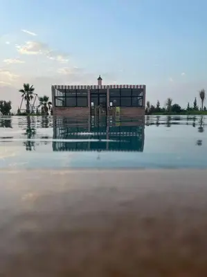 a building in the middle of a body of water at Igrane House in Marrakech