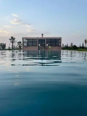 a building in the middle of a body of water at Igrane House in Marrakech