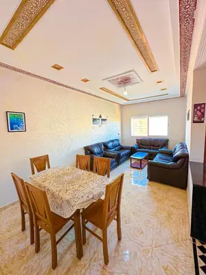 a living room with a table and a couch at Soofhouse in Fès