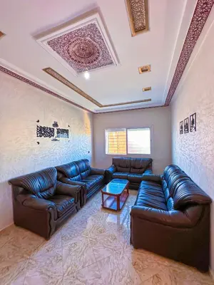 a living room with leather couches and a ceiling at Soofhouse in Fès