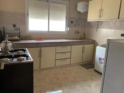 a kitchen with white cabinets and a stove top oven at Soofhouse in Fès