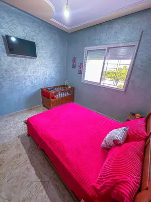 a large red bed in a bedroom with a window at Soofhouse in Fès