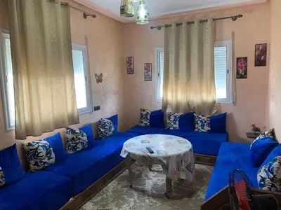a living room with blue couches and a table at Soofhouse in Fès