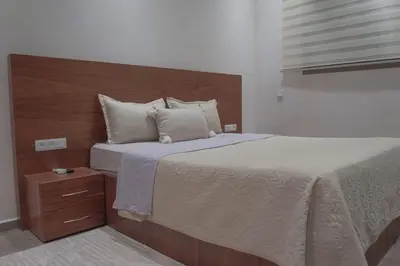 a bedroom with a large bed with a wooden headboard at Villa Treasure of Marrakech in Marrakech