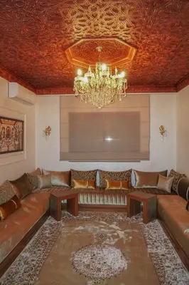 a living room with a couch and a chandelier at Villa Treasure of Marrakech in Marrakech