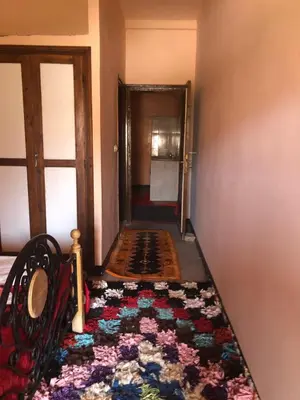 a hallway with a rug on the floor next to a door at ACHAHOUD CHEz LA BELLE FIBULLE in Aït Fars