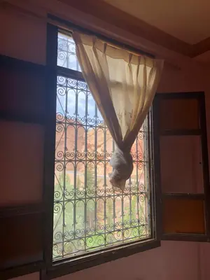a window with a curtain in a room at ACHAHOUD CHEz LA BELLE FIBULLE in Aït Fars