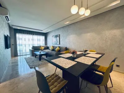 a living room with a table and a couch at Lo Belle Vie à Perstigia in Fès