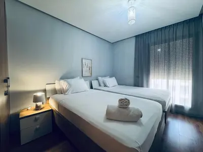 a hotel room with two beds and a window at Lo Belle Vie à Perstigia in Fès