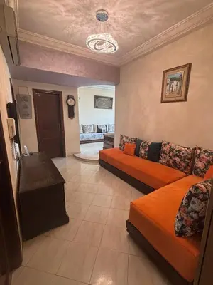 a living room with two beds and a table at Cozy Corner Getaway, Fez 4th floor in Fès