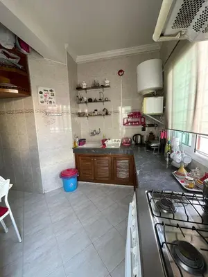a kitchen with a sink and a stove in it at Cozy Corner Getaway, Fez 4th floor in Fès