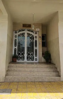 a front door of a building with stairs and a gate at Cozy Corner Getaway, Fez 4th floor in Fès