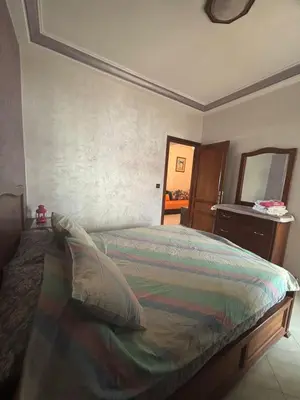 a bedroom with a bed with a dresser and a mirror at Cozy Corner Getaway, Fez 4th floor in Fès