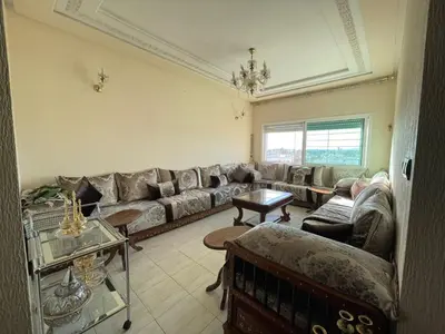 a living room with a couch and a table at Cozy Corner Getaway, Fez 4th floor in Fès