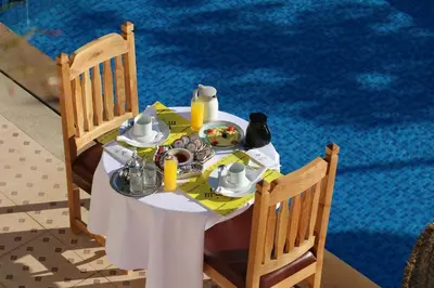 a table with a plate of food on it at Maison D'hôtes IMINIGRAN & Spa in Ouarzazate
