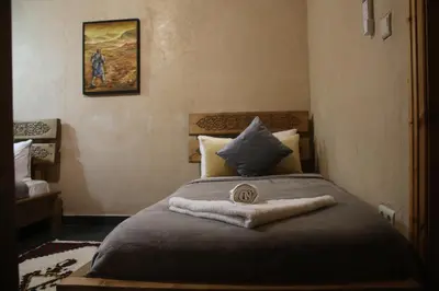 a bedroom with a bed with a towel on it at Maison D'hôtes IMINIGRAN & Spa in Ouarzazate