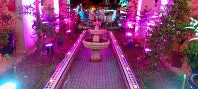 a room with a fountain with purple lights at Maison D'hôtes IMINIGRAN & Spa in Ouarzazate