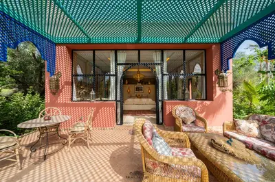 a living room with a couch and a table at Palais Hassoun Marrakech in Oulad Snaguia